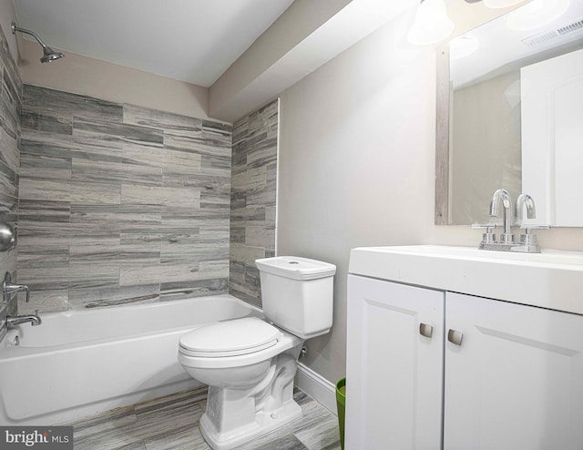 full bathroom with vanity, toilet, and tiled shower / bath combo