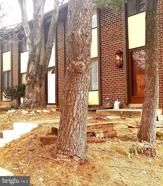 exterior space featuring brick siding