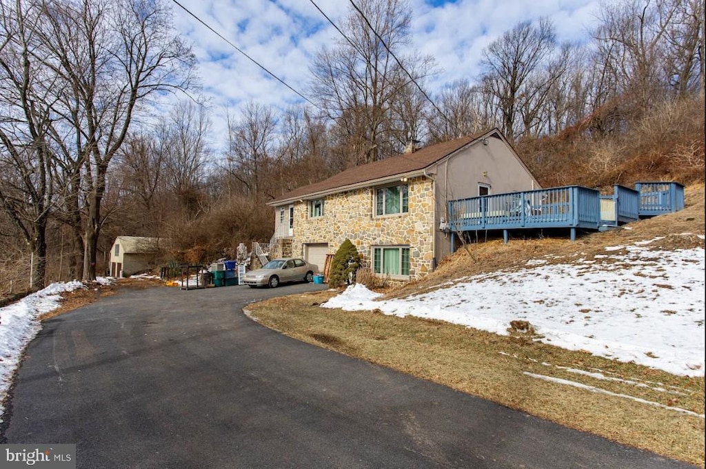 exterior space with a garage and a wooden deck