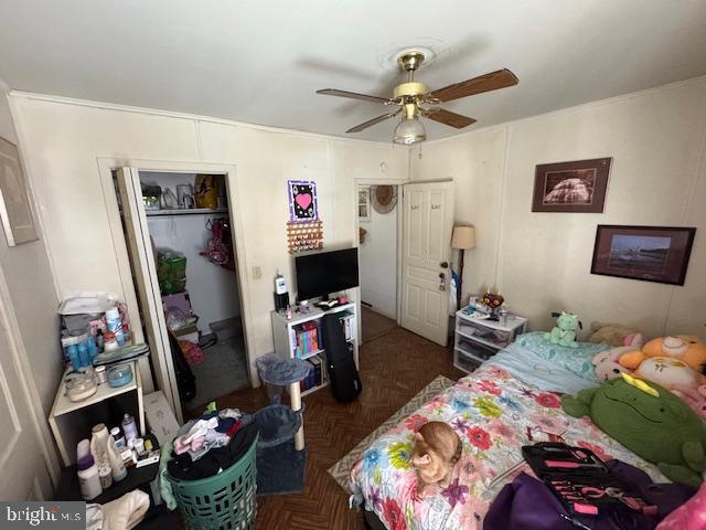 bedroom featuring dark parquet floors and ceiling fan