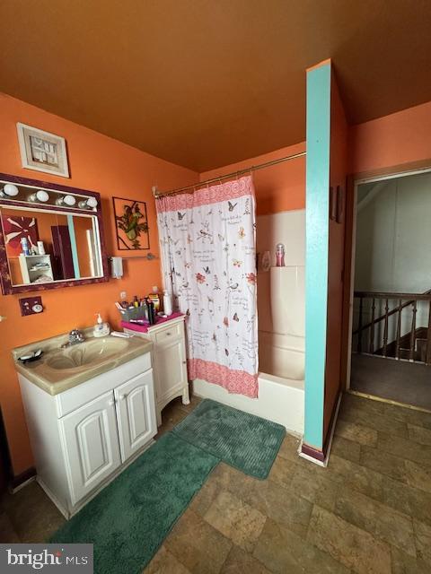 bathroom with vanity and shower / bath combo with shower curtain