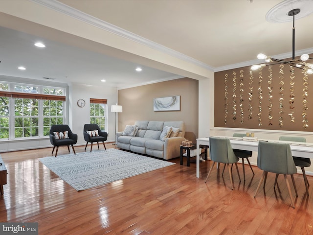 living room featuring crown molding and light hardwood / wood-style floors