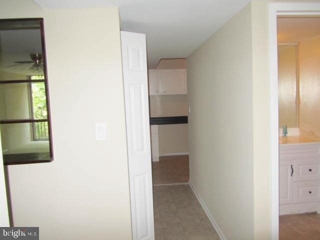 hall featuring light tile patterned floors