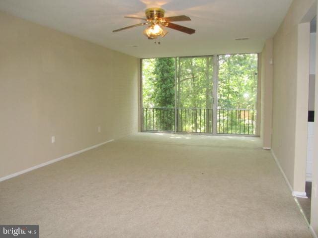 empty room with light colored carpet and ceiling fan