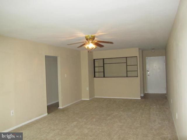 unfurnished room featuring light colored carpet and ceiling fan