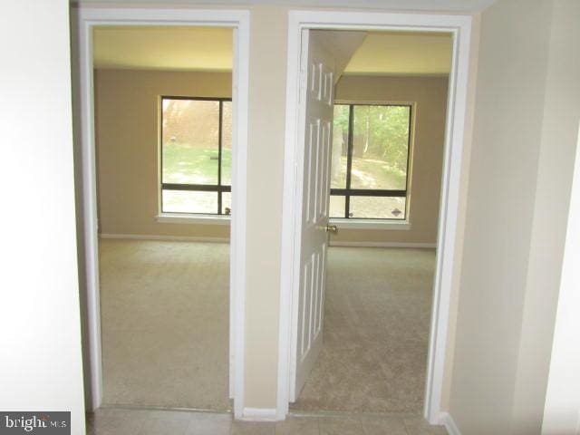 corridor with light colored carpet