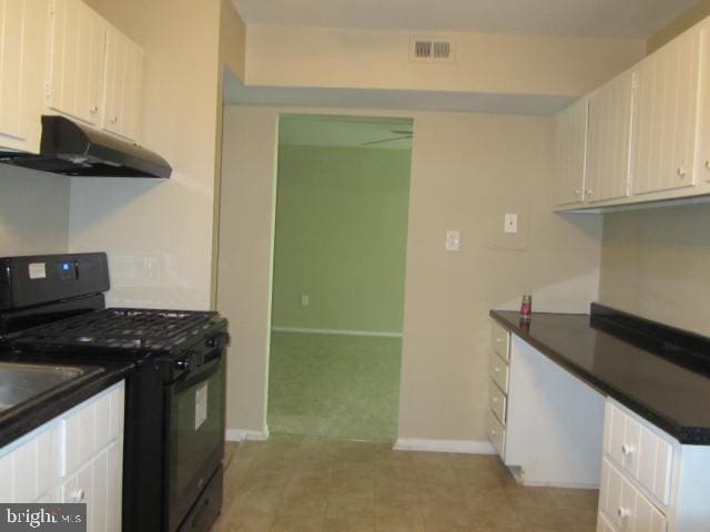 kitchen featuring white cabinetry and gas stove