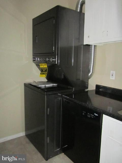 kitchen with dark stone countertops and black dishwasher