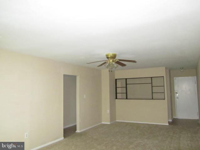 unfurnished room featuring carpet floors and ceiling fan