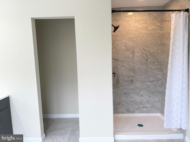 bathroom featuring walk in shower and vanity