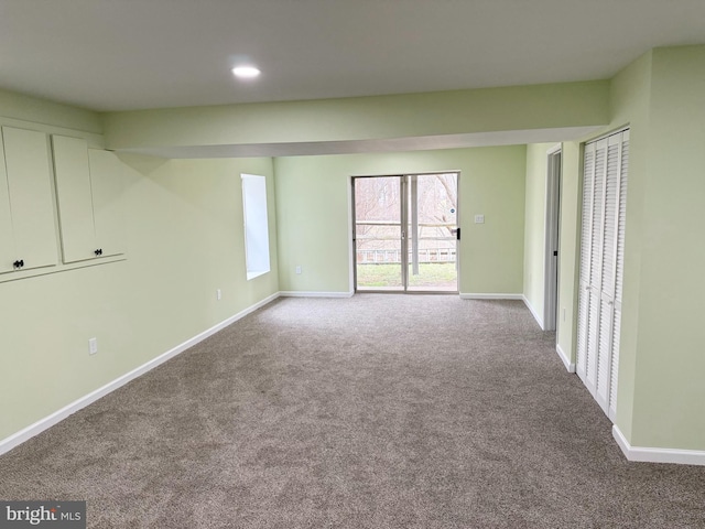 carpeted spare room featuring recessed lighting and baseboards