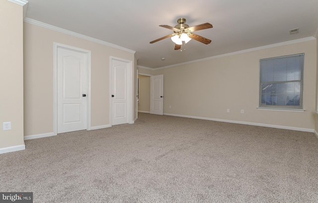 interior space featuring visible vents, baseboards, carpet, and ornamental molding