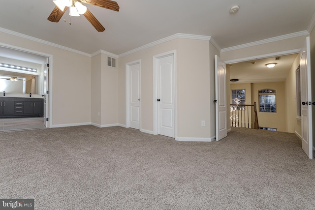 unfurnished bedroom with visible vents, ornamental molding, baseboards, and carpet floors