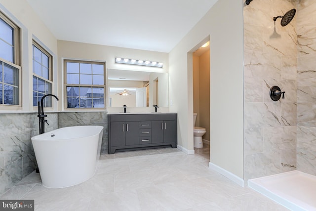 bathroom featuring vanity, toilet, and tiled shower