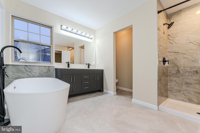 full bathroom featuring baseboards, toilet, tiled shower, a soaking tub, and vanity