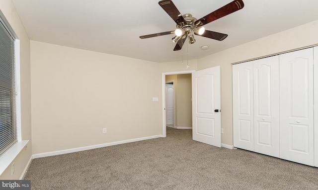 unfurnished bedroom featuring a closet, baseboards, and carpet