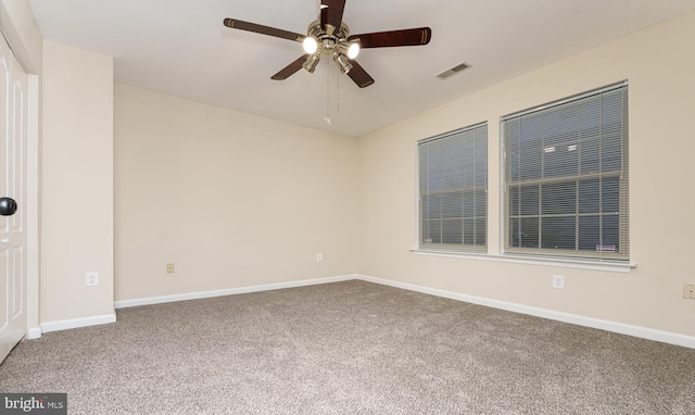 unfurnished room featuring visible vents, baseboards, ceiling fan, and carpet flooring