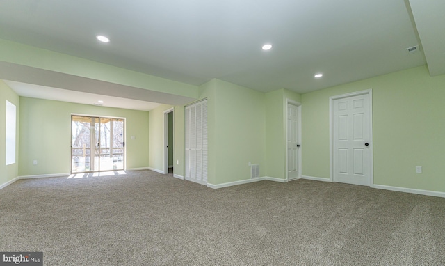 unfurnished room with carpet flooring, recessed lighting, visible vents, and baseboards