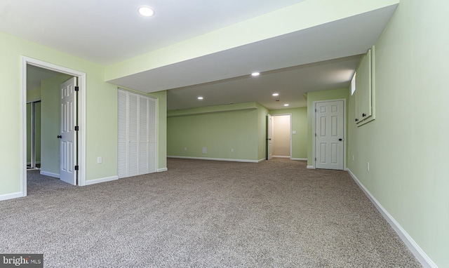 spare room with recessed lighting, baseboards, and carpet