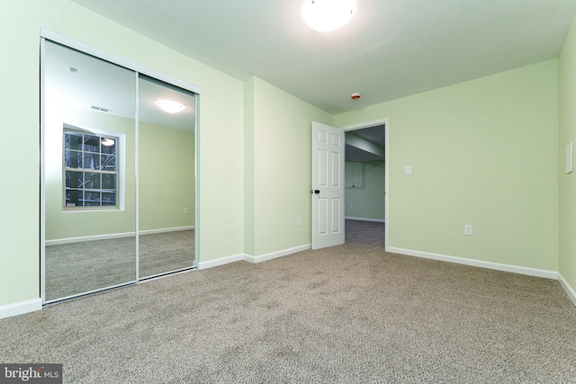 unfurnished bedroom featuring visible vents, carpet, a closet, and baseboards