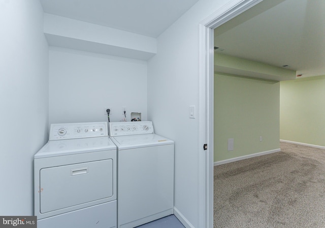 clothes washing area featuring carpet flooring, independent washer and dryer, laundry area, and baseboards