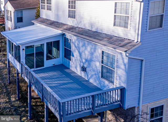 back of house with a deck and a sunroom