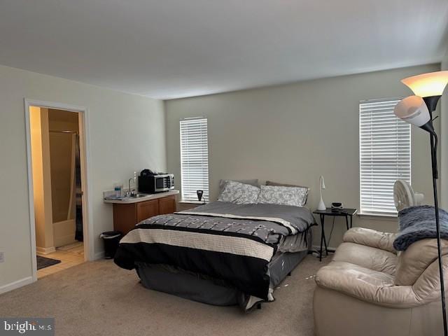 carpeted bedroom with multiple windows