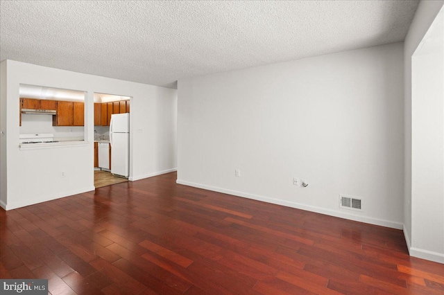 unfurnished living room featuring dark hardwood / wood-style floors and a textured ceiling