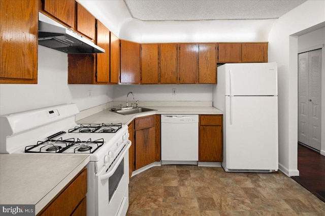 kitchen featuring sink, a textured ceiling, and white appliances