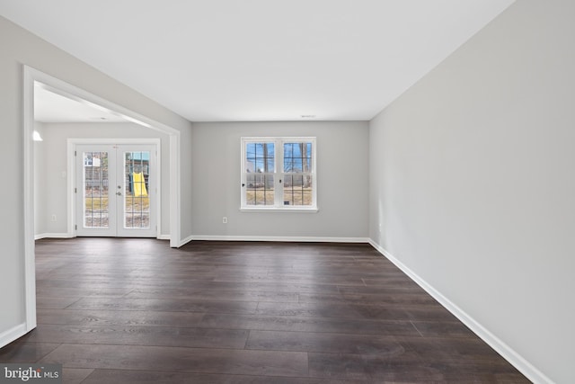 unfurnished room with french doors, plenty of natural light, and dark hardwood / wood-style floors