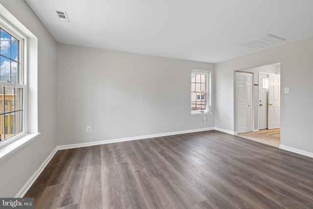 spare room with dark hardwood / wood-style floors