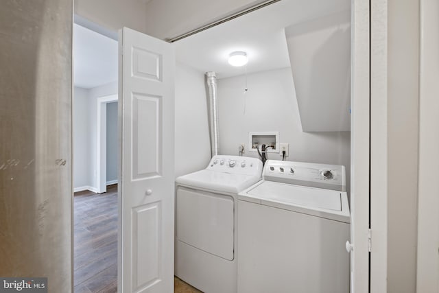 clothes washing area featuring hardwood / wood-style floors and independent washer and dryer