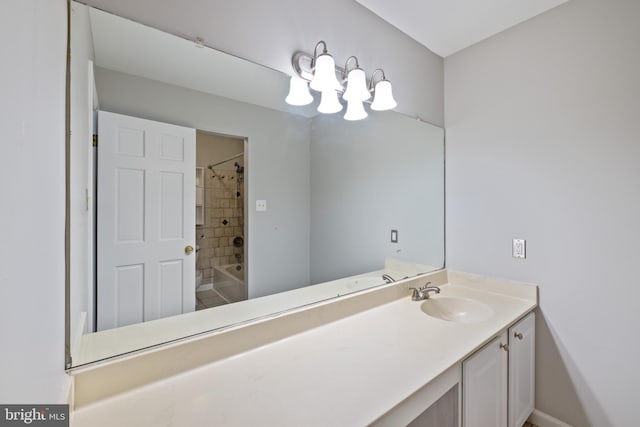 bathroom with tiled shower / bath and vanity