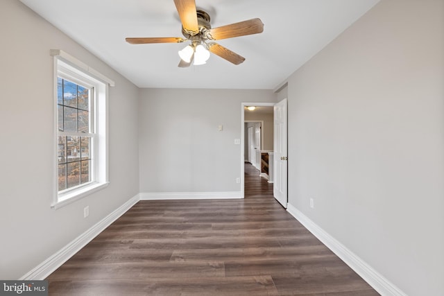 spare room featuring ceiling fan and dark hardwood / wood-style flooring