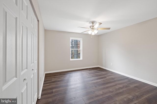 unfurnished bedroom featuring ceiling fan, dark hardwood / wood-style floors, and a closet