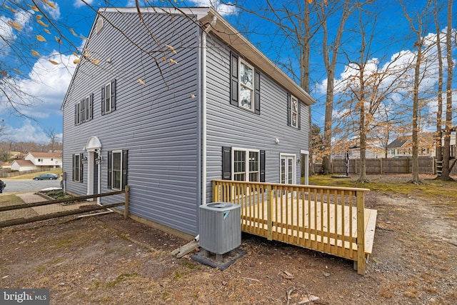 view of side of home featuring central AC and a deck