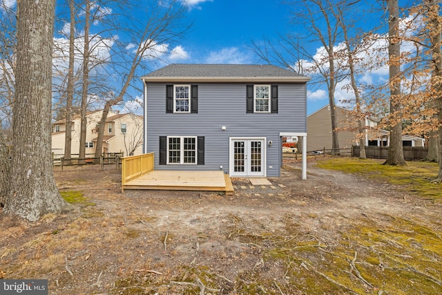 rear view of property featuring a wooden deck and french doors