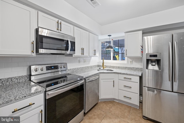 kitchen with sink, appliances with stainless steel finishes, backsplash, light stone counters, and white cabinets