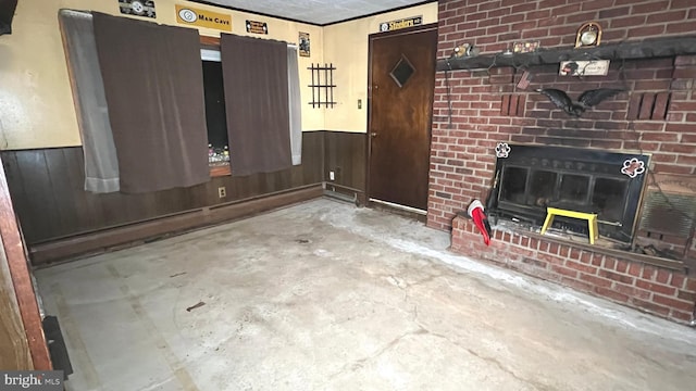 unfurnished living room featuring wooden walls