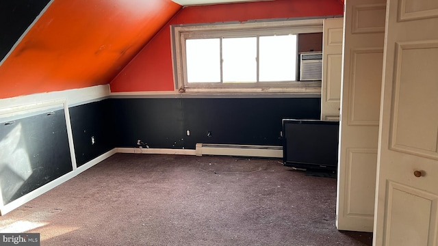 additional living space featuring baseboard heating, lofted ceiling, and carpet