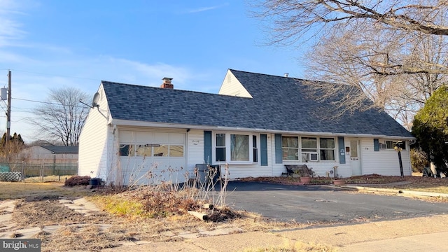 view of front of property with cooling unit and a garage