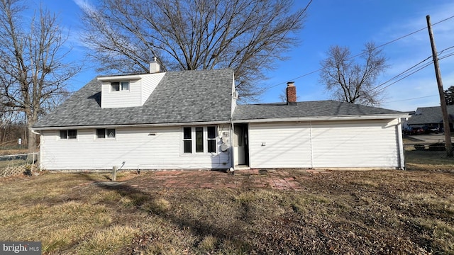 rear view of house featuring a yard