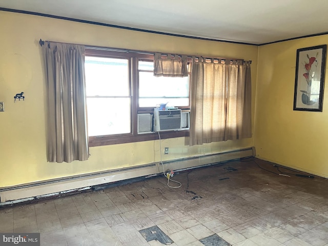 spare room with cooling unit and baseboard heating