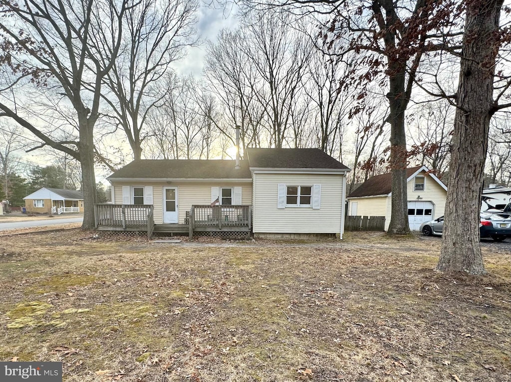 view of front facade with a garage, an outdoor structure, and a deck