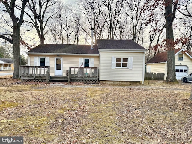 view of front of house with a wooden deck and a garage