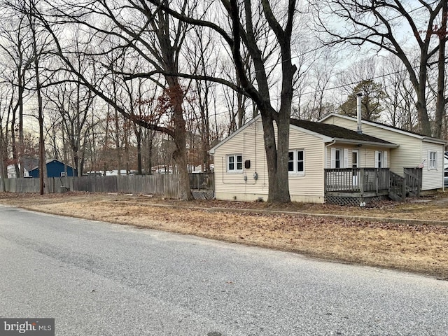 view of home's exterior featuring a wooden deck