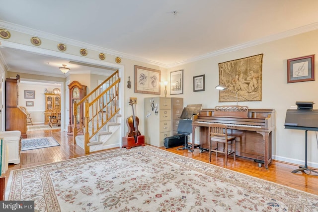 misc room with hardwood / wood-style flooring and crown molding