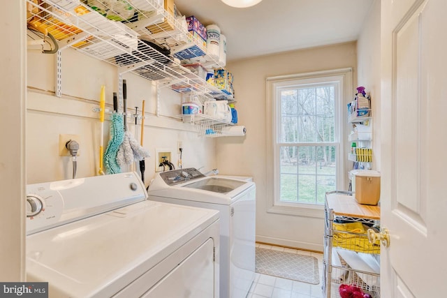 laundry room featuring washer and dryer and light tile patterned floors