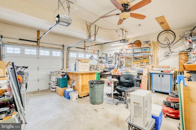 garage with a garage door opener, ceiling fan, and a workshop area