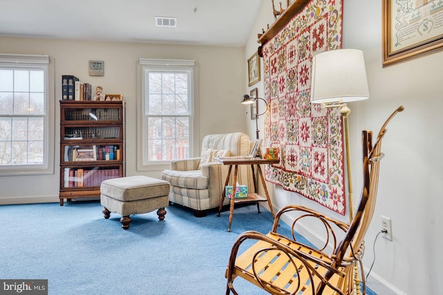 living area featuring plenty of natural light and carpet floors